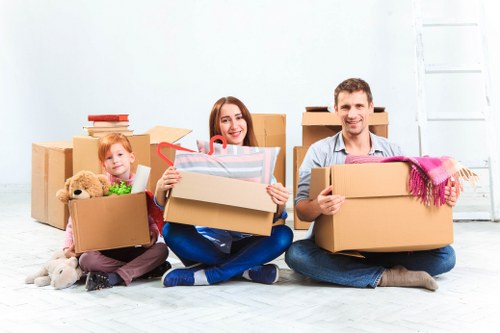 Removalists carefully transporting furniture during a house move in Primrosehill